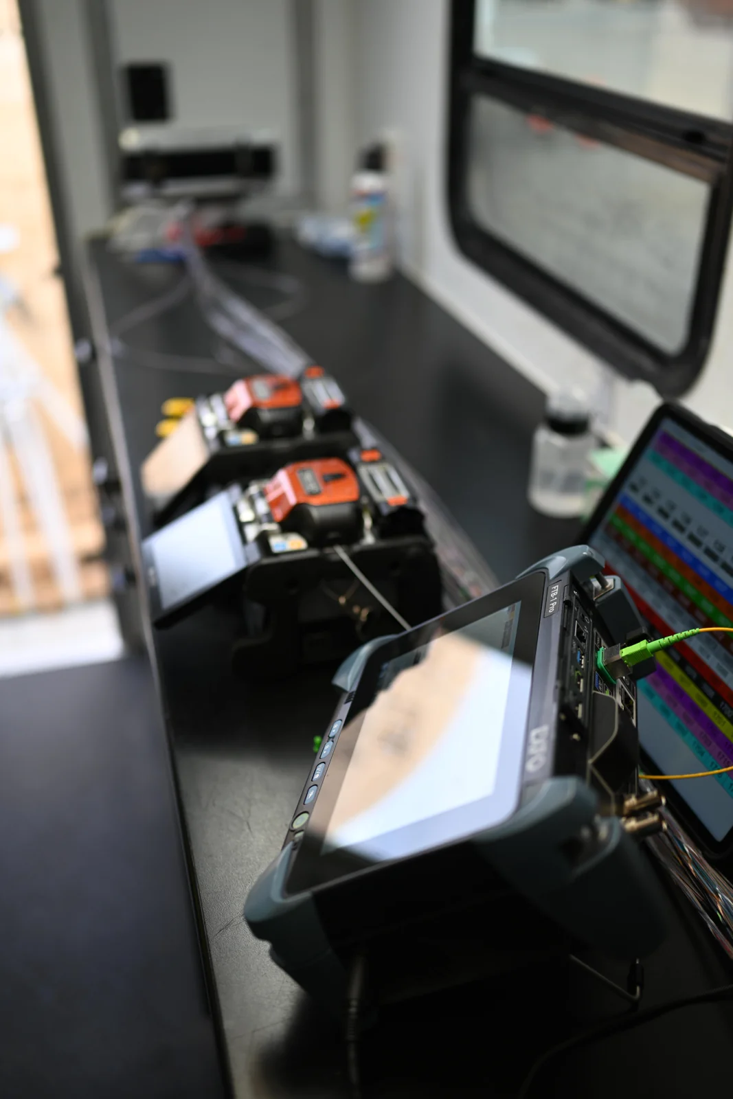 Fiber testing equipment connected to optical fibers at an Altum Star workstation